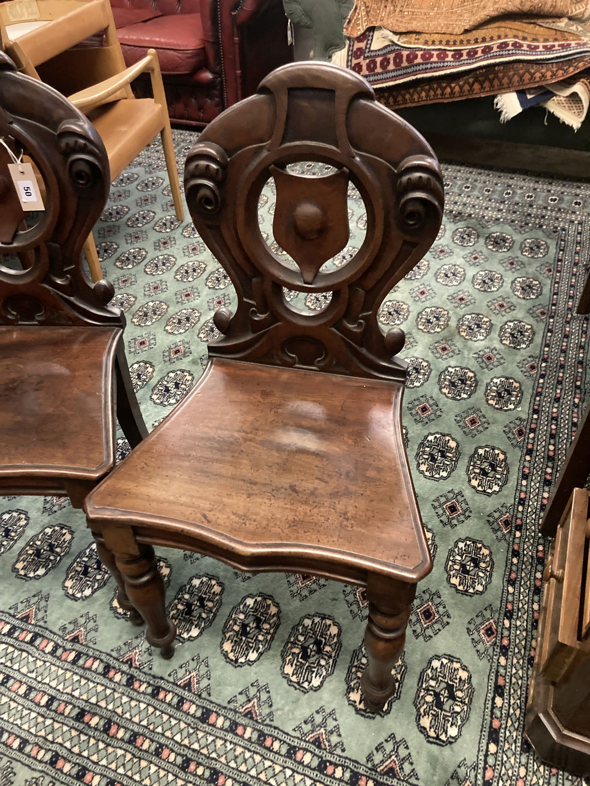 A pair of Victorian mahogany hall chairs